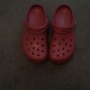 Burgundy crocs .